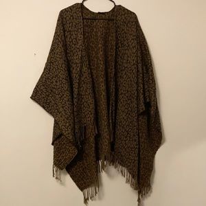 Woman’s oversized leopard poncho